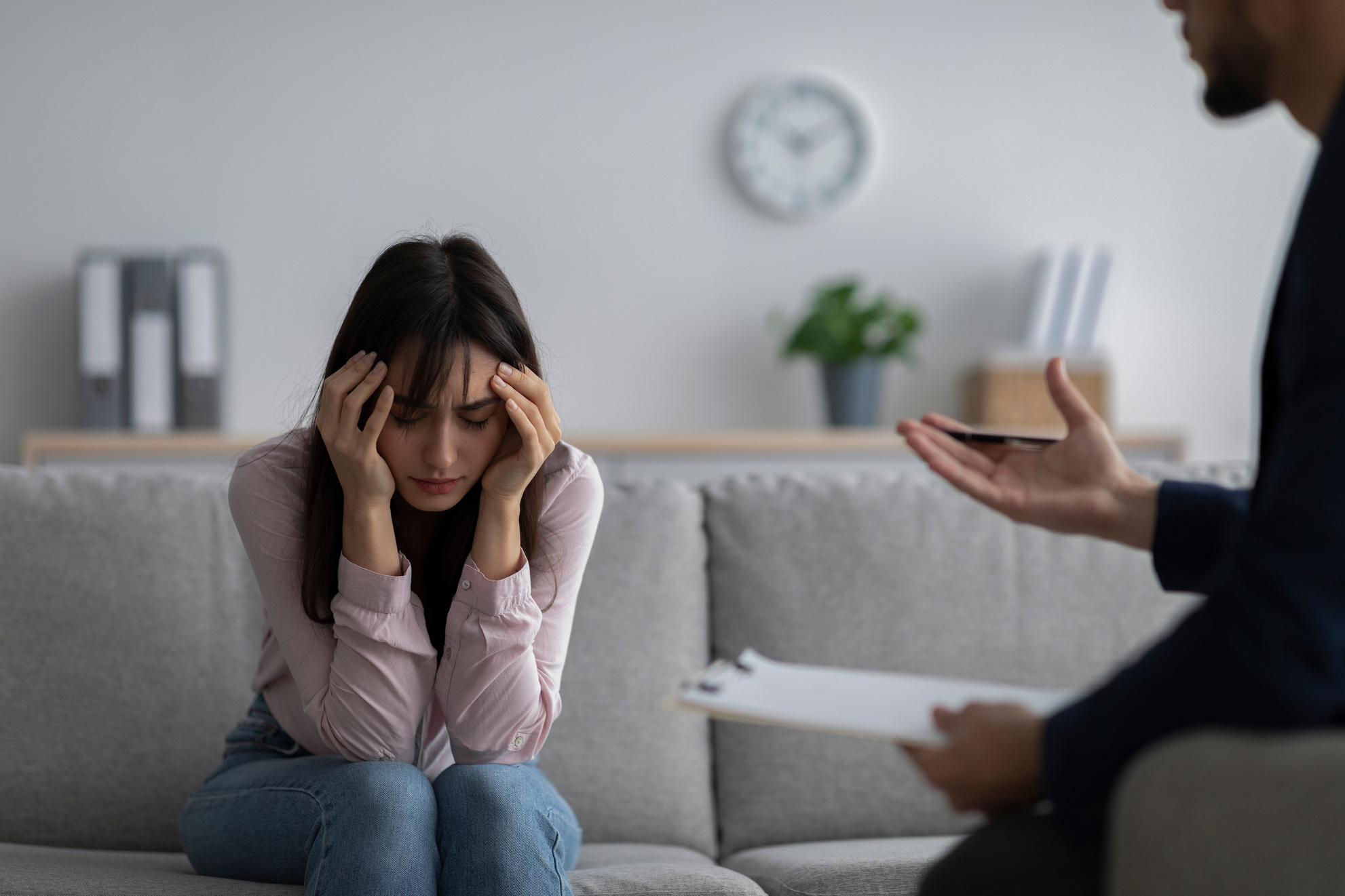 Depressed Young Woman Touching Head, Seeking Professional Help with Mental Disorder at Psychotherapist's Office